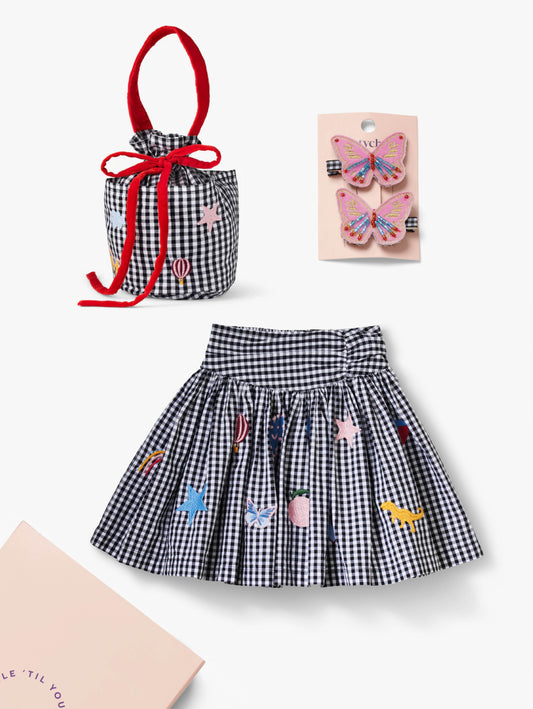 Stych Kids gingham skirt with embroidered designs, matching pocket bucket bag, and pink butterfly hair clips Pack of 2 wrapped in tissue in a reuseable slide out gift box