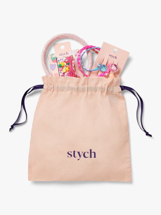 Stych Girls Gift in a drawstring bag that includes Make Your Own Jewellery Making Kit, 3 pack Faux Hair Plait Hair Clips, and Ivory Pink Colour Sequin Sparkle Headband 