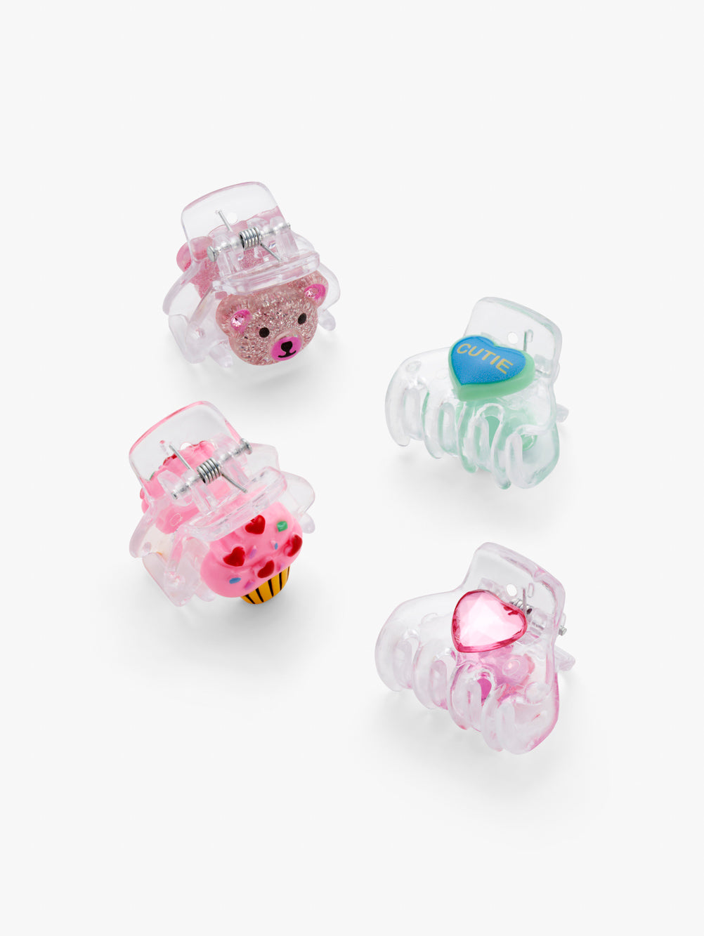 Stych Girls Set of 4 transparent mini hair claw clips with colourful teddy face, cupcake and heart decorative detailing. 